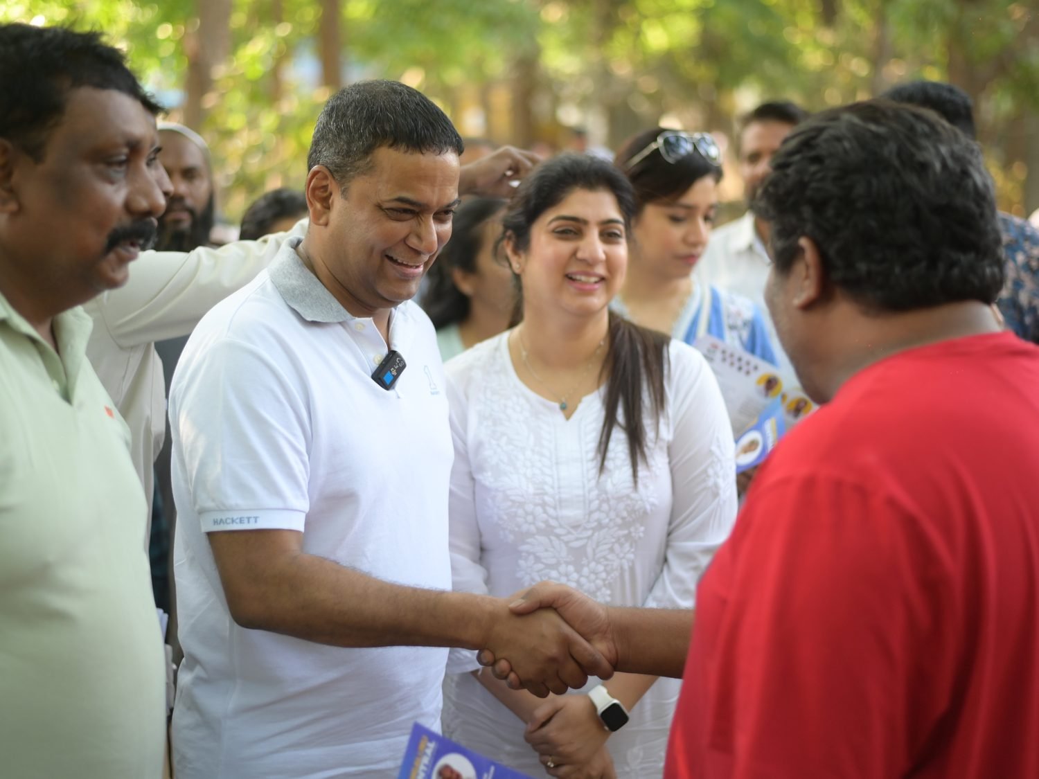 Mansoor Ali Khan greeting a resident during a community visit.