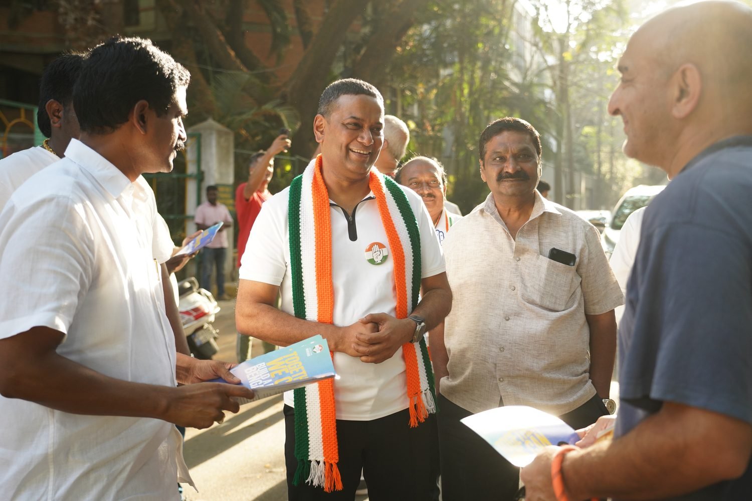 Mansoor Ali Khan with Congress workers during a neighbourhood campaign, a party scarf around his neck.