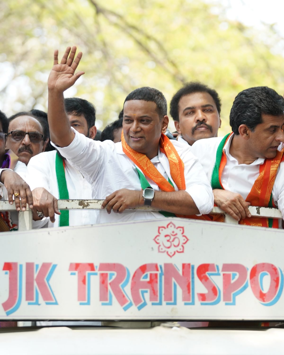 Mansoor Ali Khan greeting supporters during a roadshow in Bengaluru.
